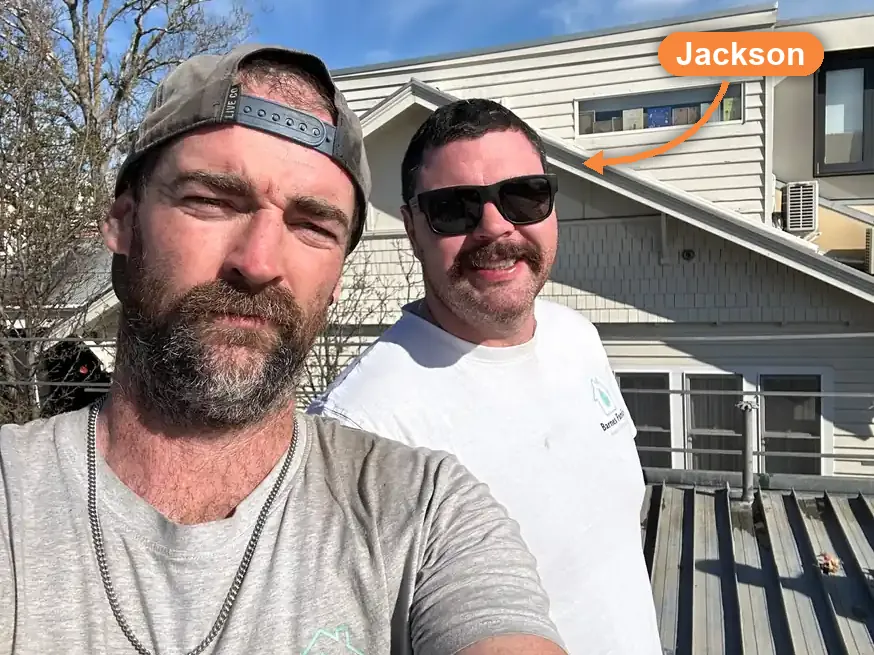 Jackson Barnes, owner of Barnes Family Roof Plumbing, labelled with an arrow, on a re-roof with one of his crew