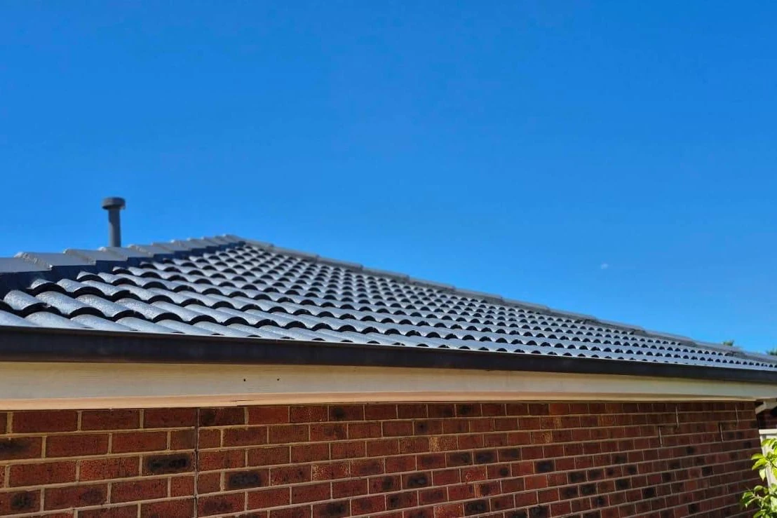 A charcoal tile roof seen from the ground